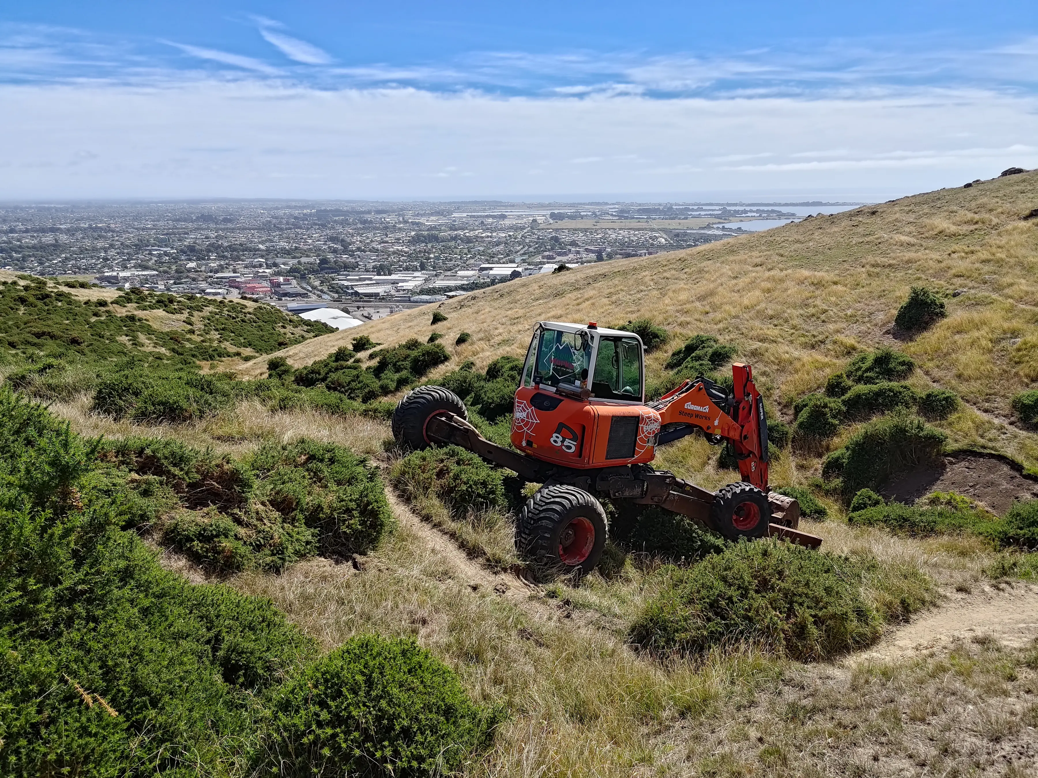Spider digger operating on steep terrain